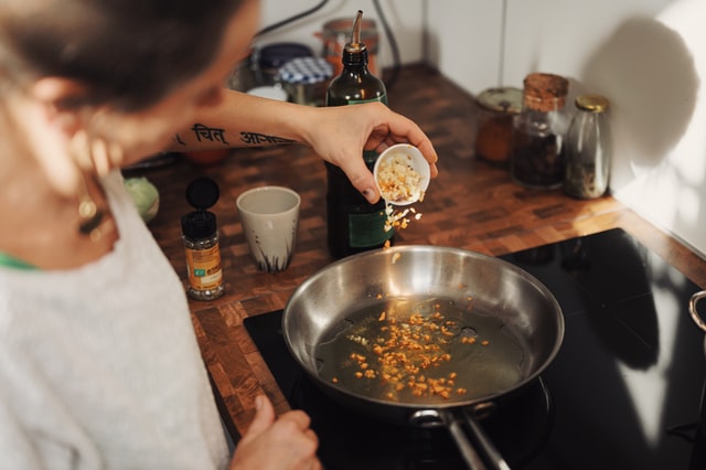 Indian women tempering while cooking to make an Indian curry