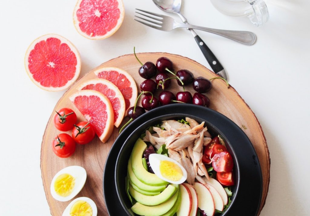 nourishing bowl chicken egg salad with citrus fruits berries and tomatoes