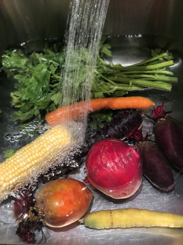 washing vegetables and fruits before meal prep